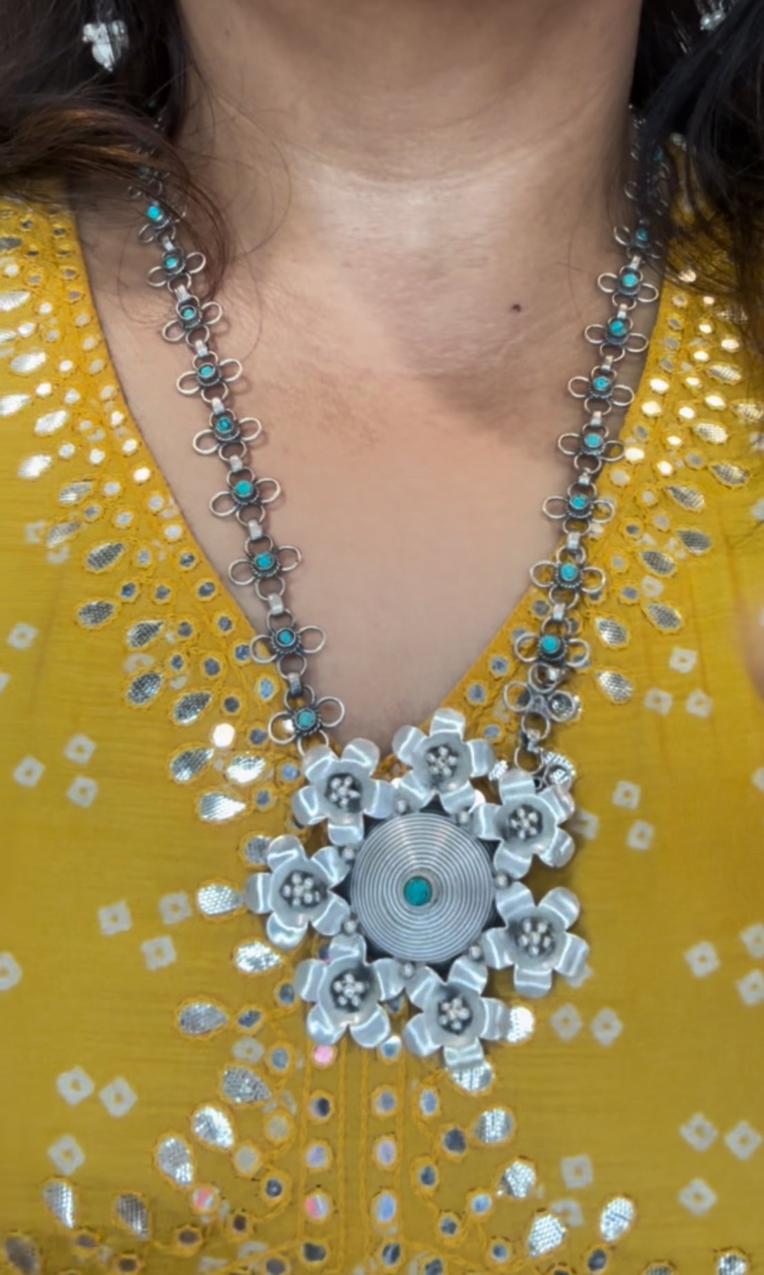 NEELU. Stunning turquoise studded necklace in pure silver with a  floral centrepiece .