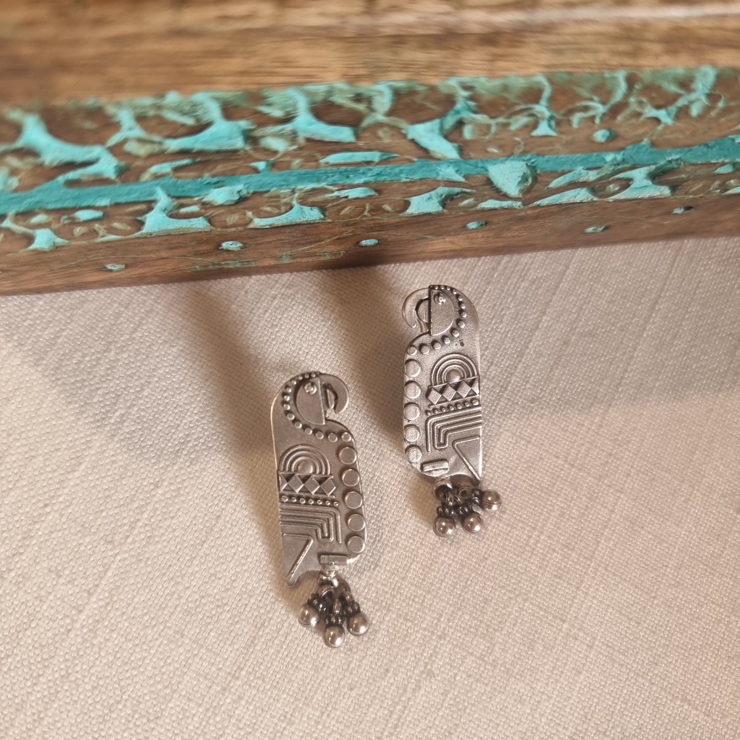 TOTA. The quirky , carved parrot earrings.