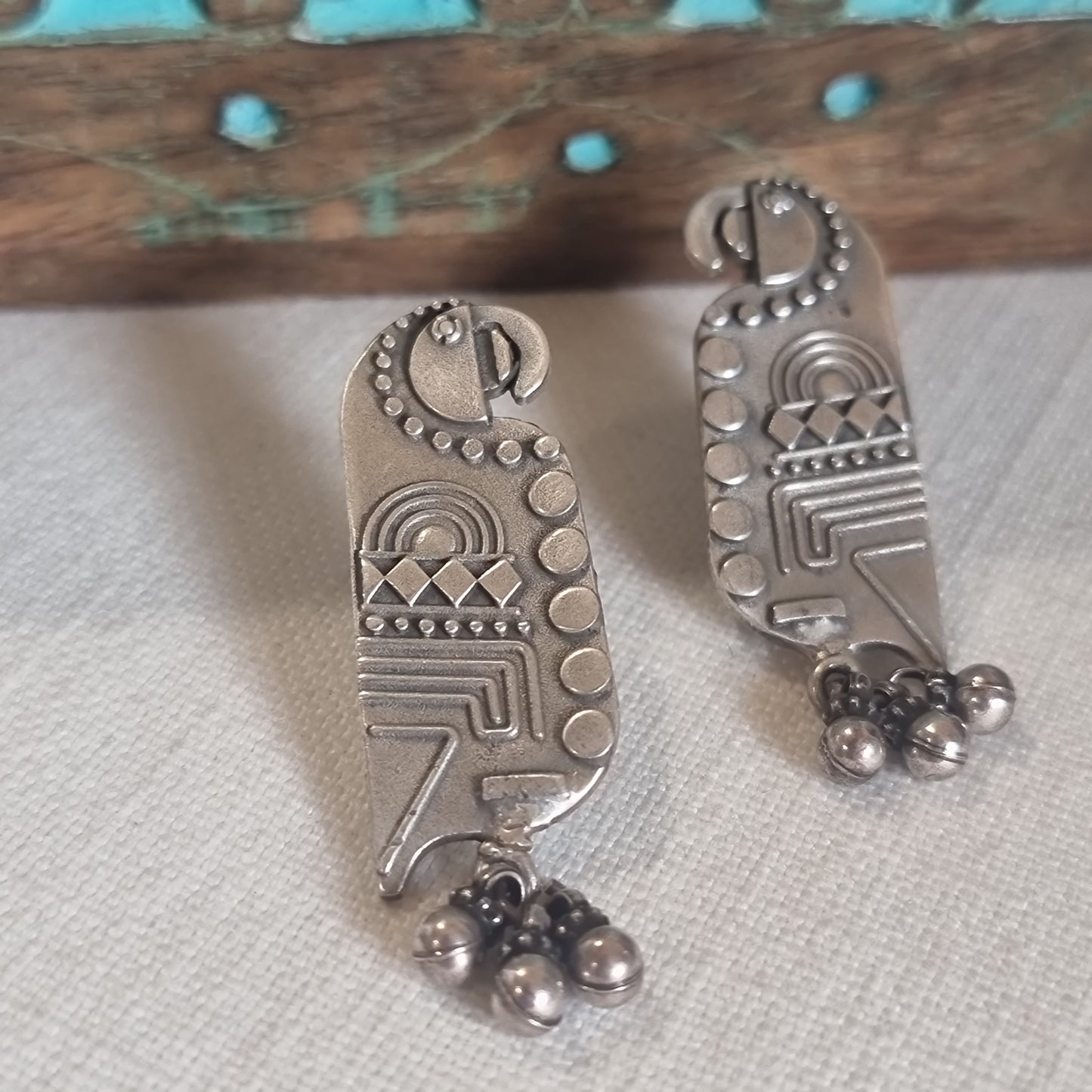 TOTA. The quirky , carved parrot earrings.